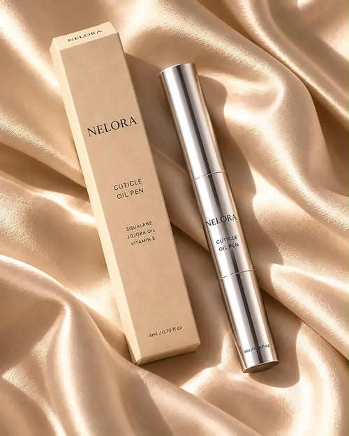 NELORA Cuticle Oil Pen and box on champagne satin